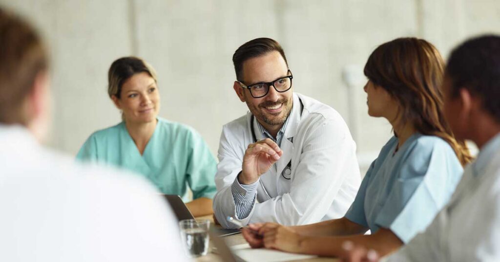Doctors and nurses having a positive and engaged discussion during a meeting