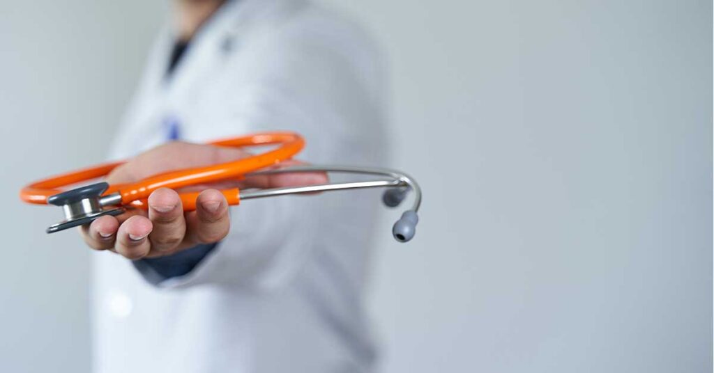 Doctor's hand holding a stethoscope closeup