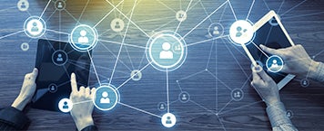 Two individuals using tablets