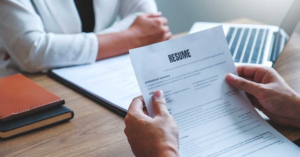 Person reviewing a resume during a job interview