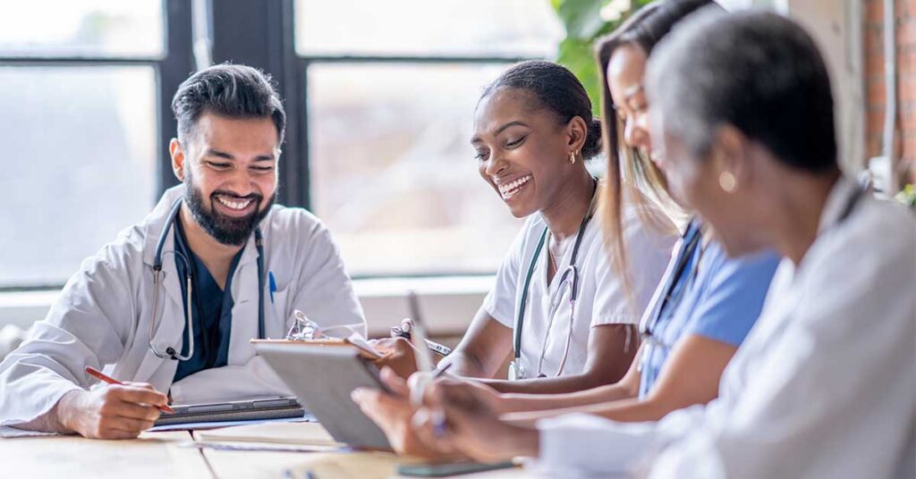 Smiling healthcare professionals collaborating during a meeting