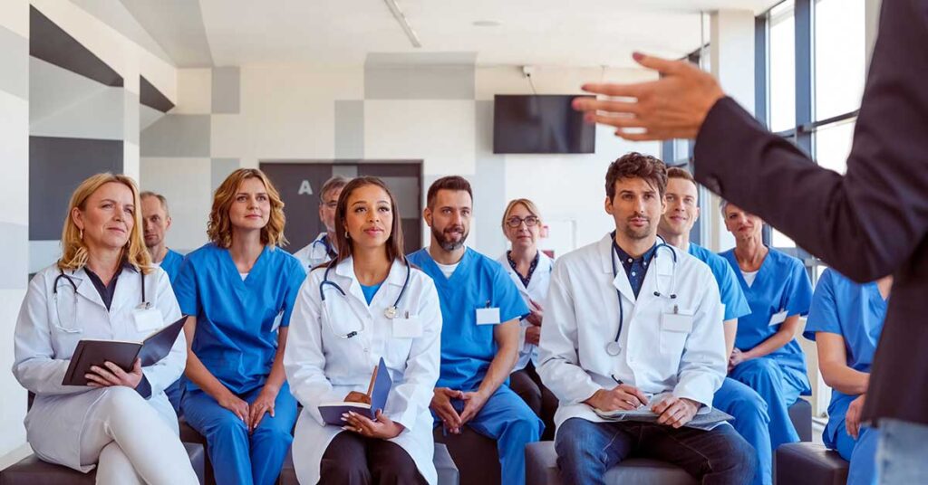 Medical professionals attentively listening during a healthcare seminar