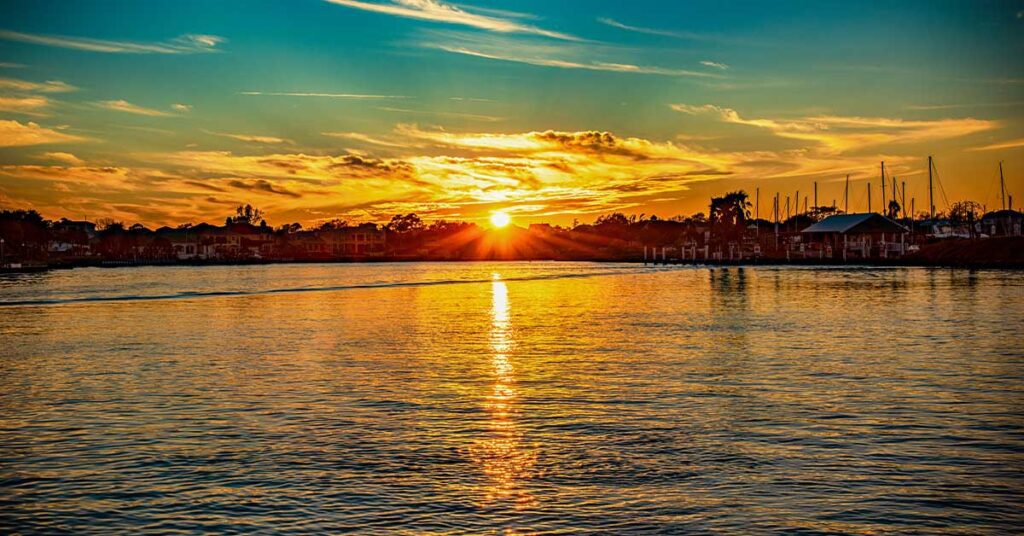 Sunset reflecting over the water with waterfront homes the background