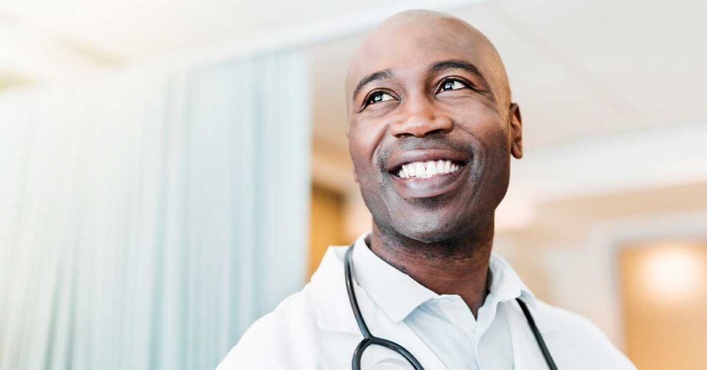 Close-up of happy confident doctor looking away
