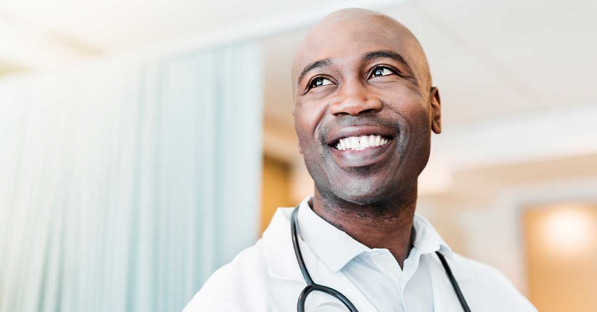 Close-up of happy confident doctor looking away