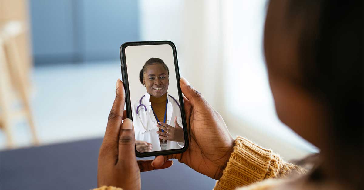 Woman watching a video of a doctor on her phone