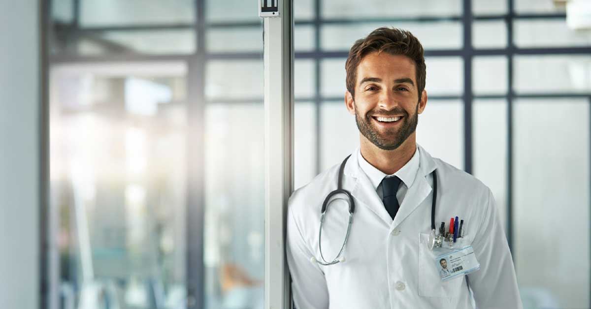 Portrait of a male doctor standing in a hospital lobby