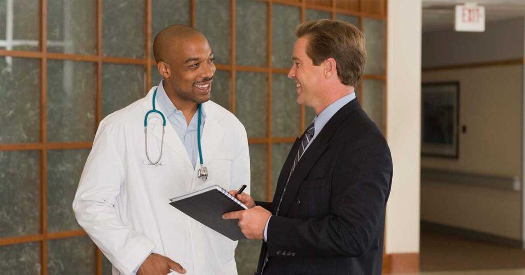 Doctor and businessman talking