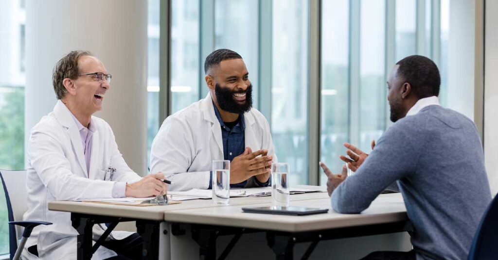 Two male doctors and a male recruiter in an interview