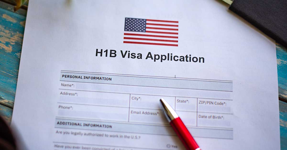 llustrative picture showing application for United States of America work visa H1B with pen