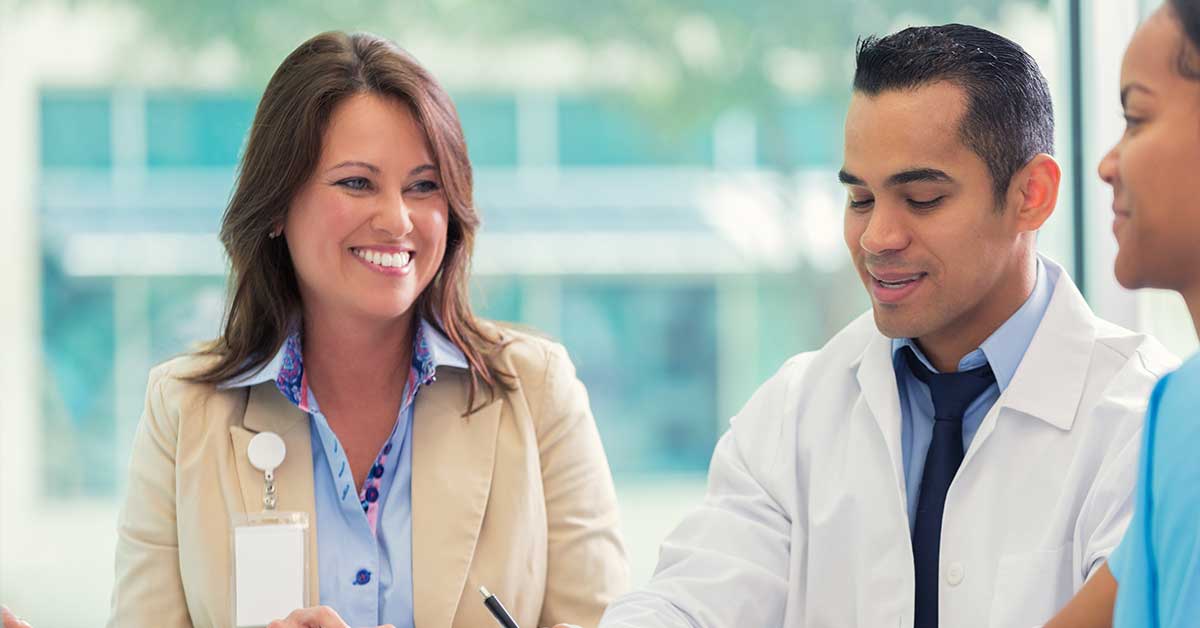 Confident doctor and hospital executive discuss strategy