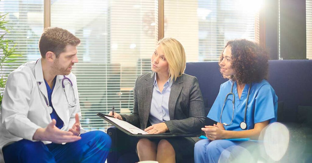Three members of hospital staff meeting