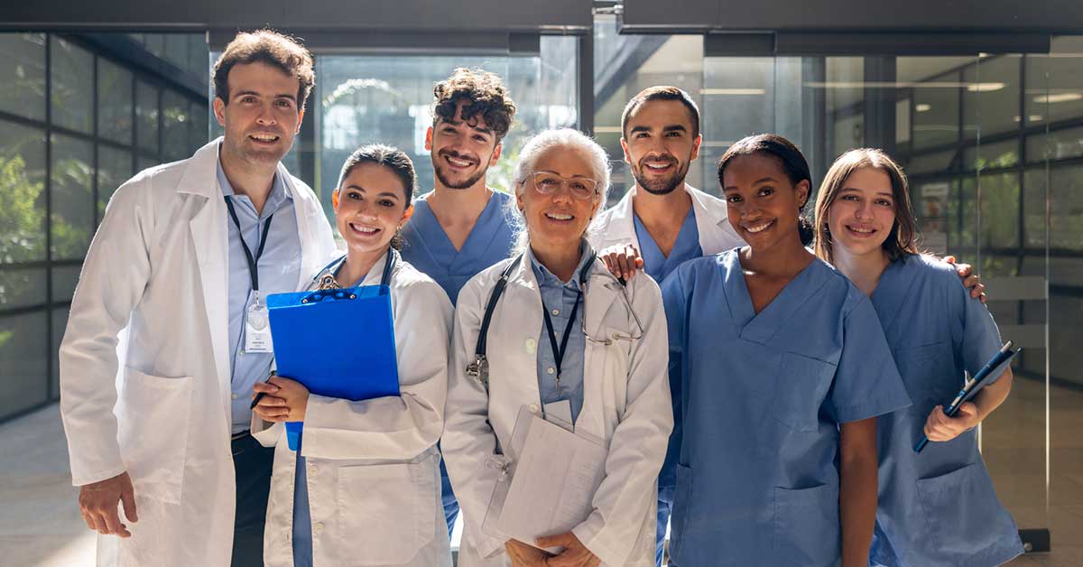 Happy group of healthcare workers smiling at the hospital