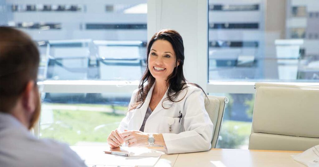 A mature adult female doctor being interviewed in a conference room