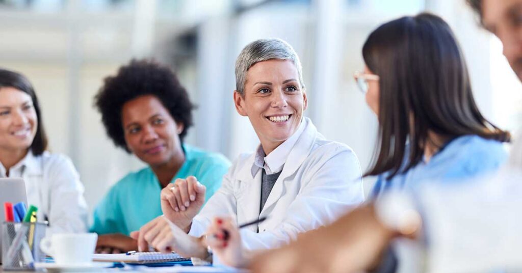 Team of happy doctors talking on a meeting in the office.